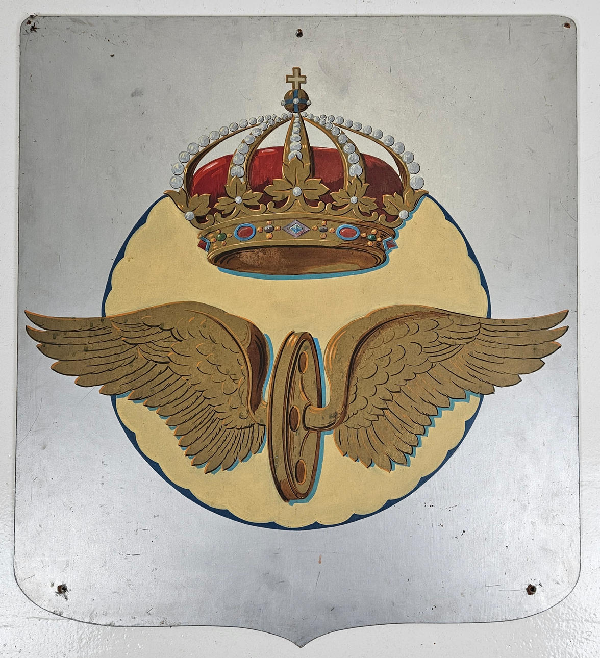 A 20th-century SJ Masonite sign, Winged Wheels.