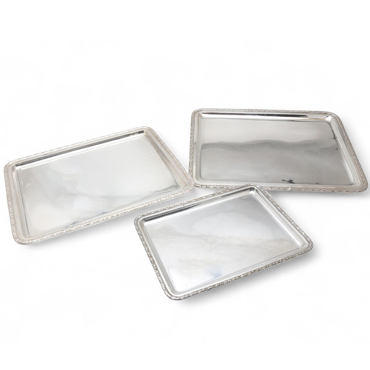 Three rectangular trays in silvery metal, 20th Century.