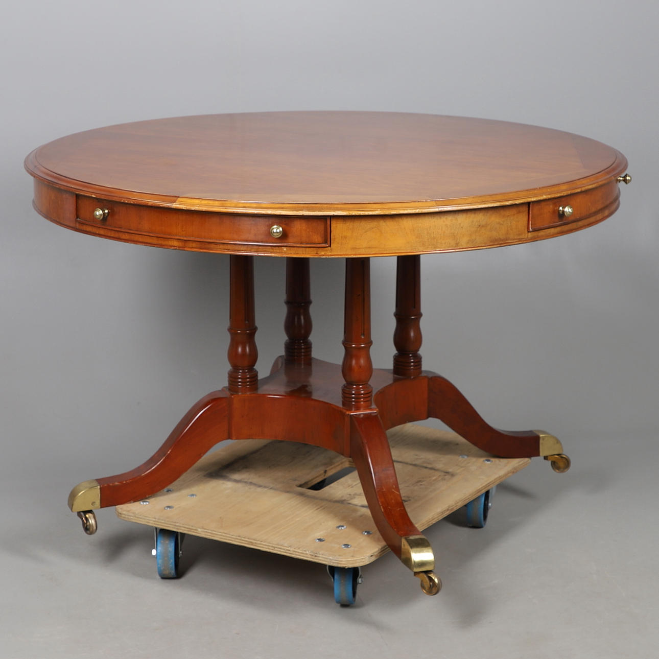 A REPRODUCTION DRUM TOP LIBRARY CENTER TABLE.