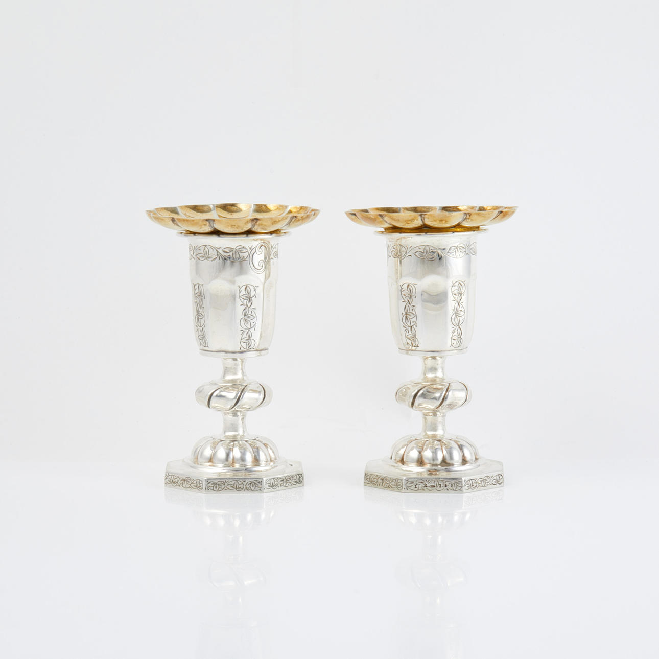 CANDLESTICKS. 1 pair, silver, octagonal foot, good crowned, engraved decor, loose candle cuff, Swedish import stamp.