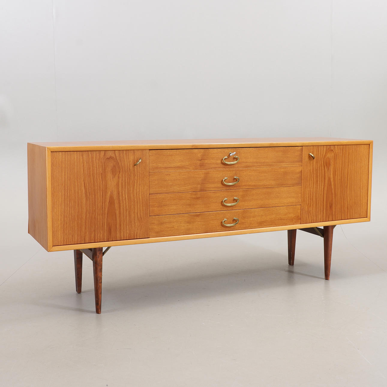A 1950's teak/birch sideboard.
