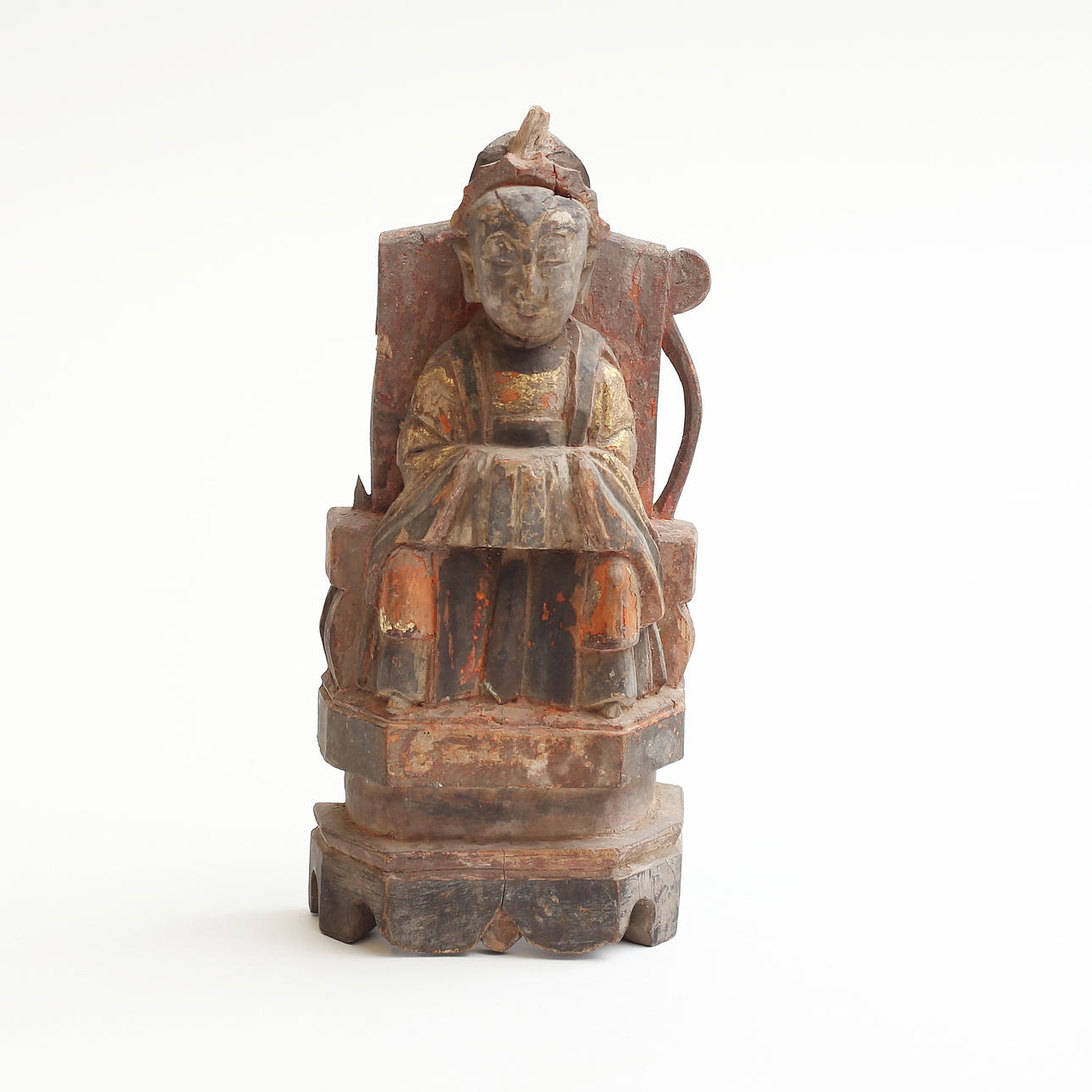 A wooden sculpture of a seated man with a relic hide on his back, China ...