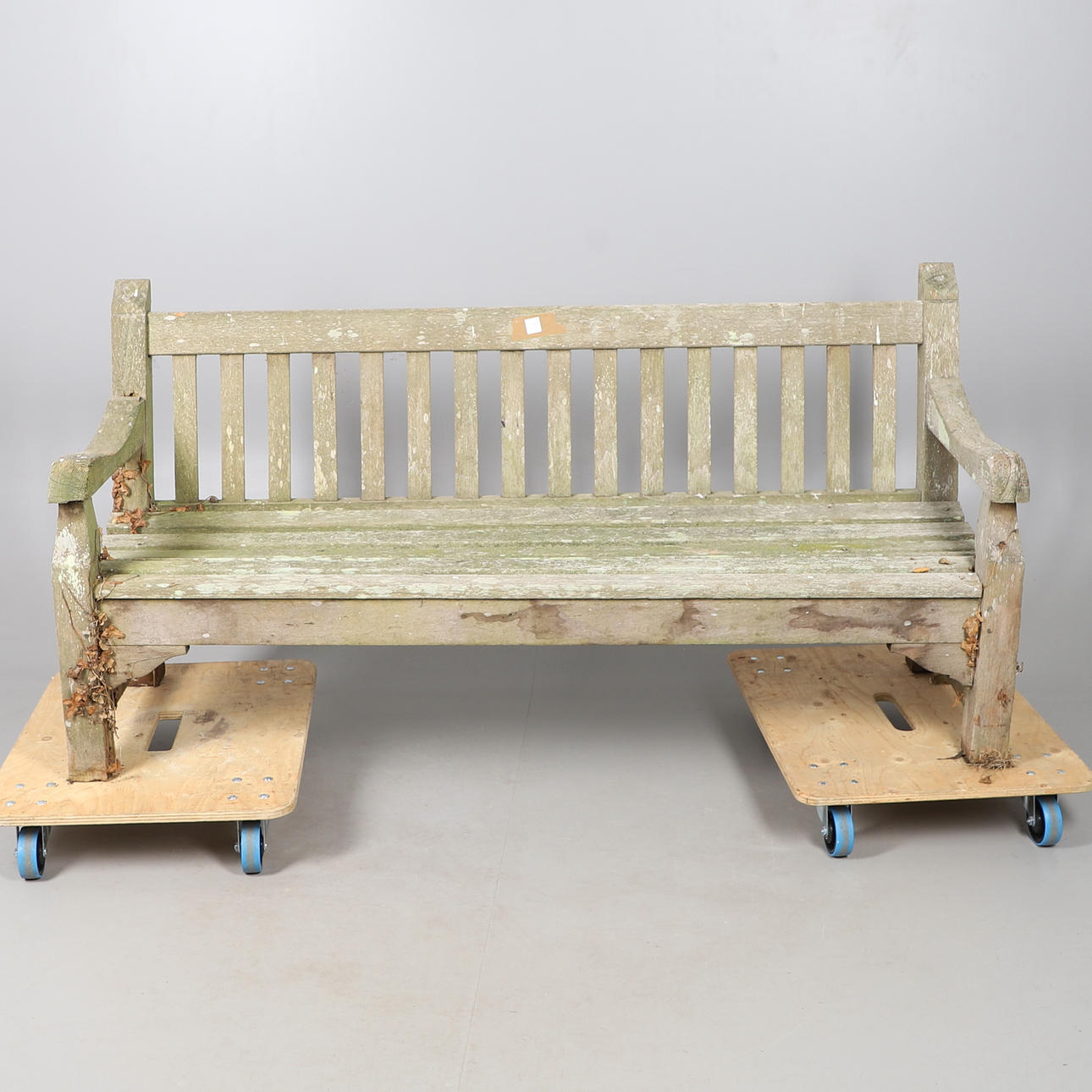 A LARGE TEAK GARDEN BENCH.