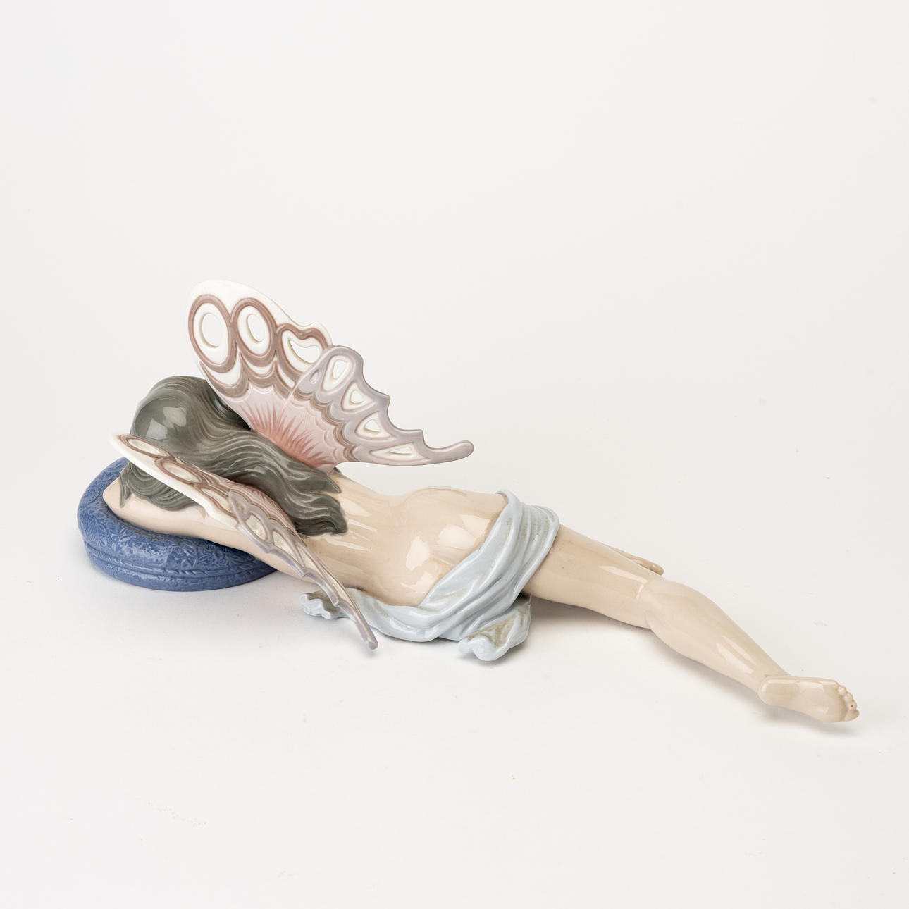 A porcelain figurine of a butterfly girl from Lladro, Spain, later part ...