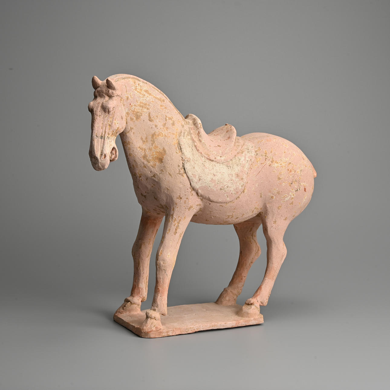 A CHINESE PAINTED BUFF POTTERY MODEL OF A HORSE WITH TL TEST, TANG ...