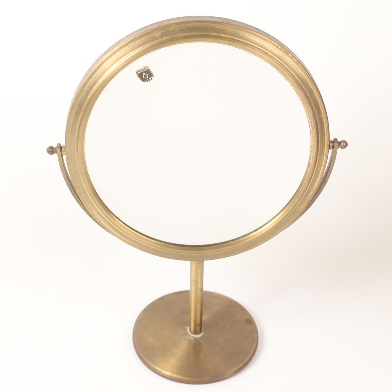 A mid-20th century brass/glass table mirror.