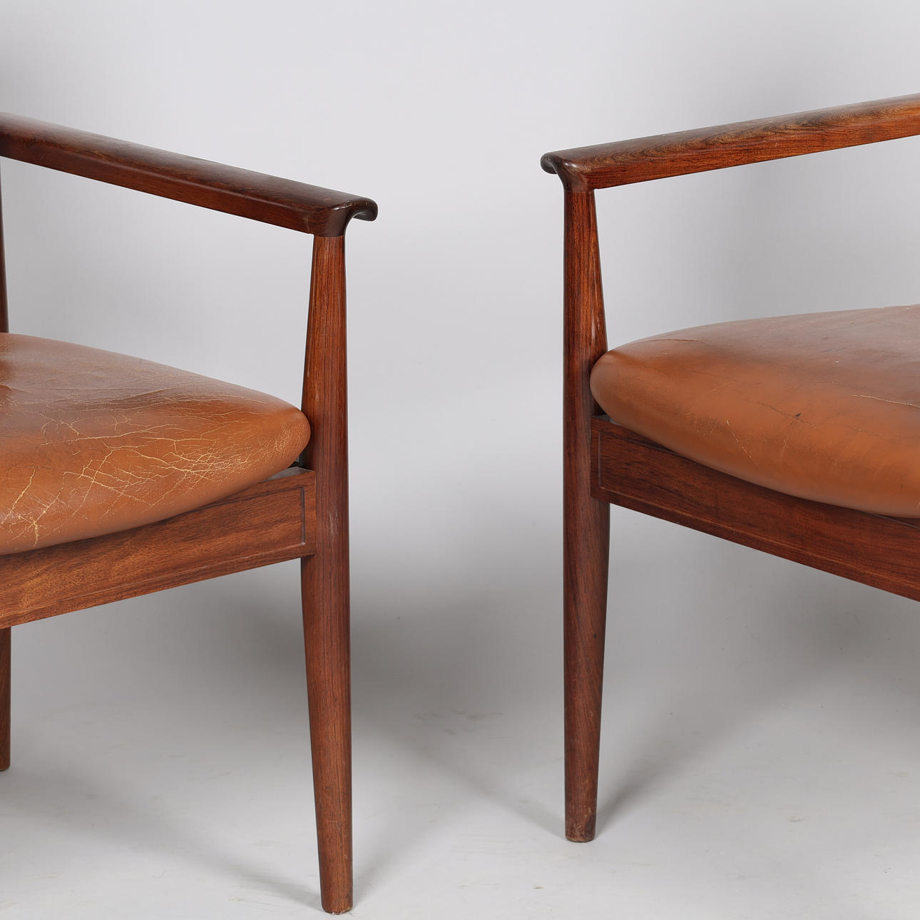 FINN JUHL. A pair of “Diplomat” armchairs, rosewood frame, seat and ...