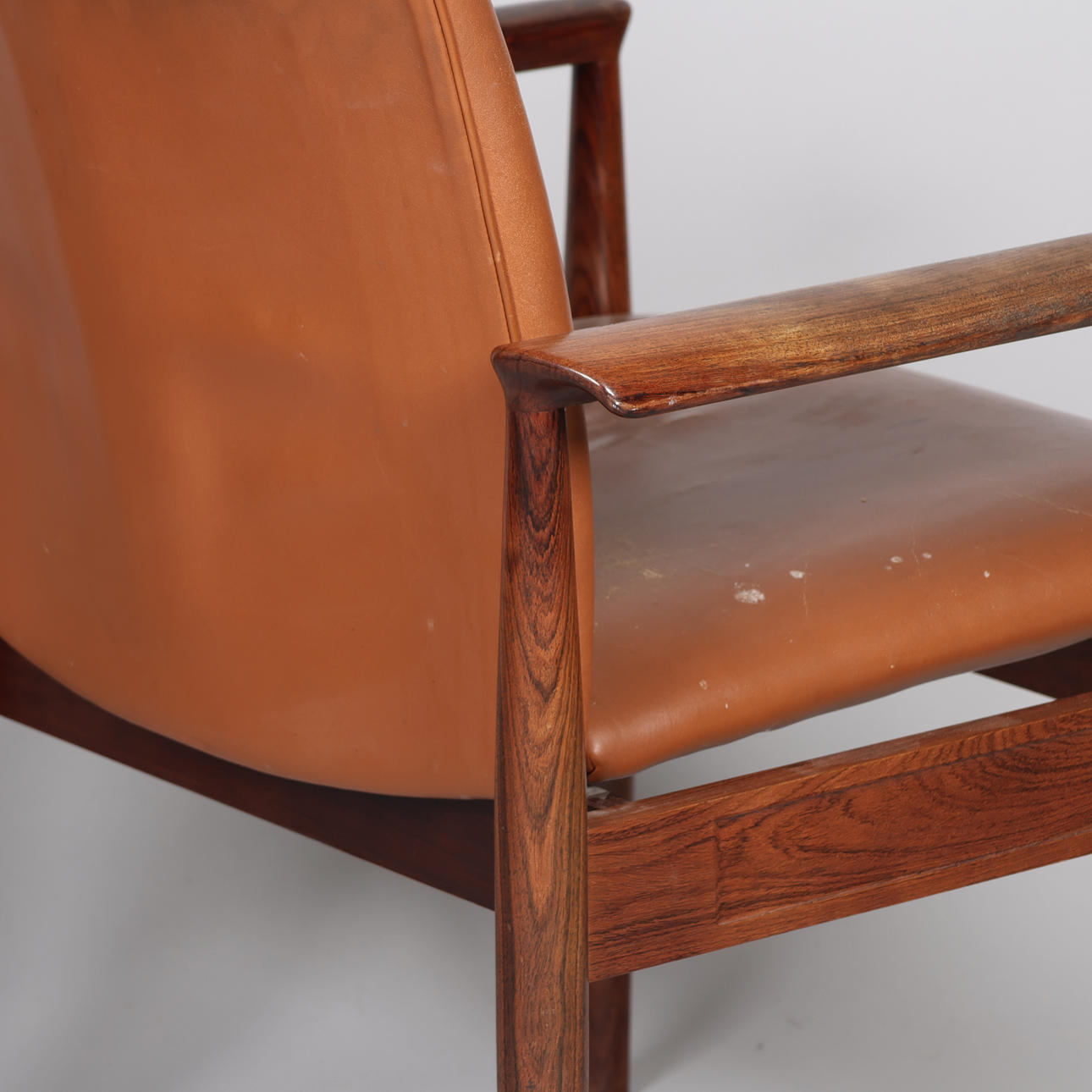 FINN JUHL. A pair of “Diplomat” armchairs, rosewood frame, seat and ...