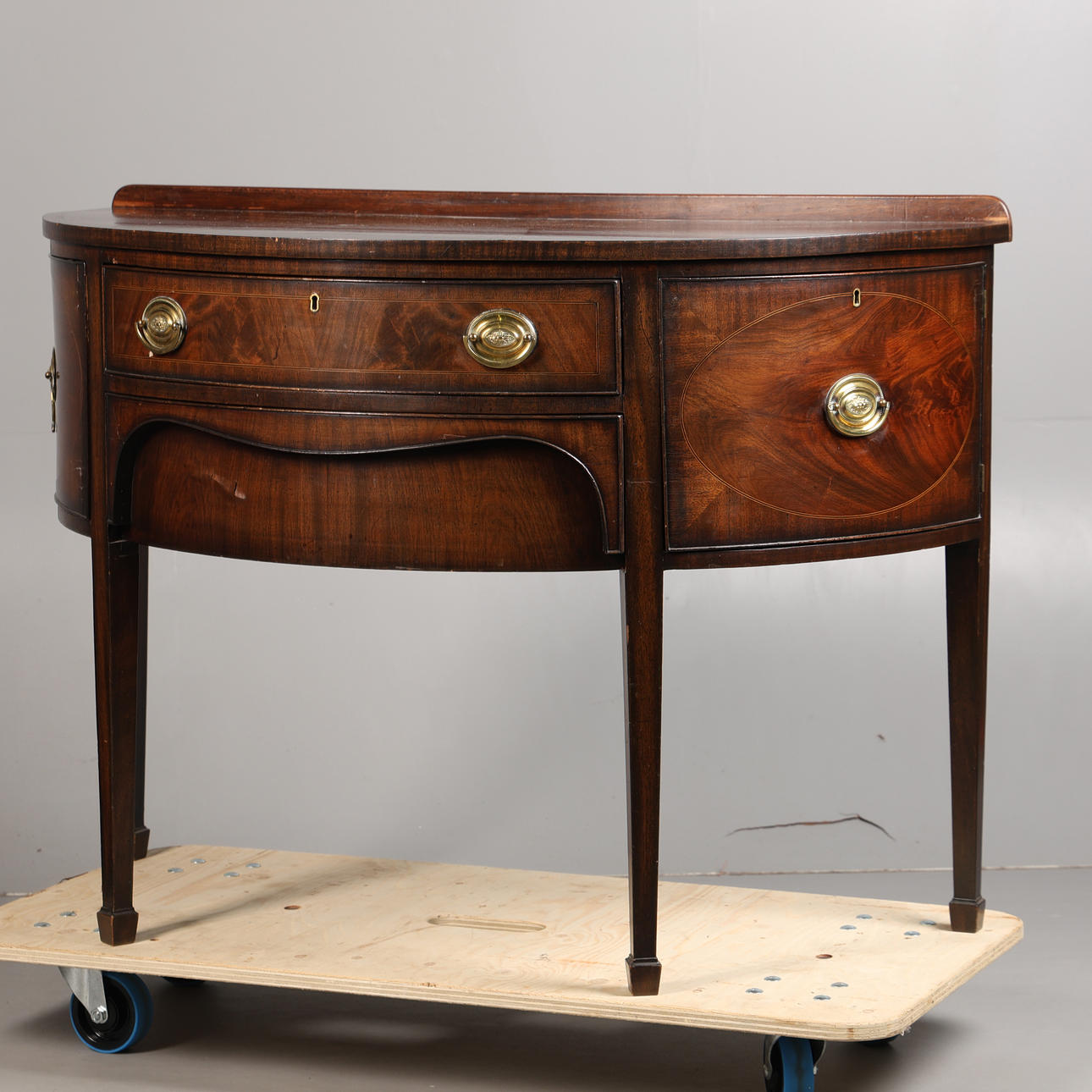 A GEORGE III MAHOGANY BOW FRONTED SIDEBOARD.