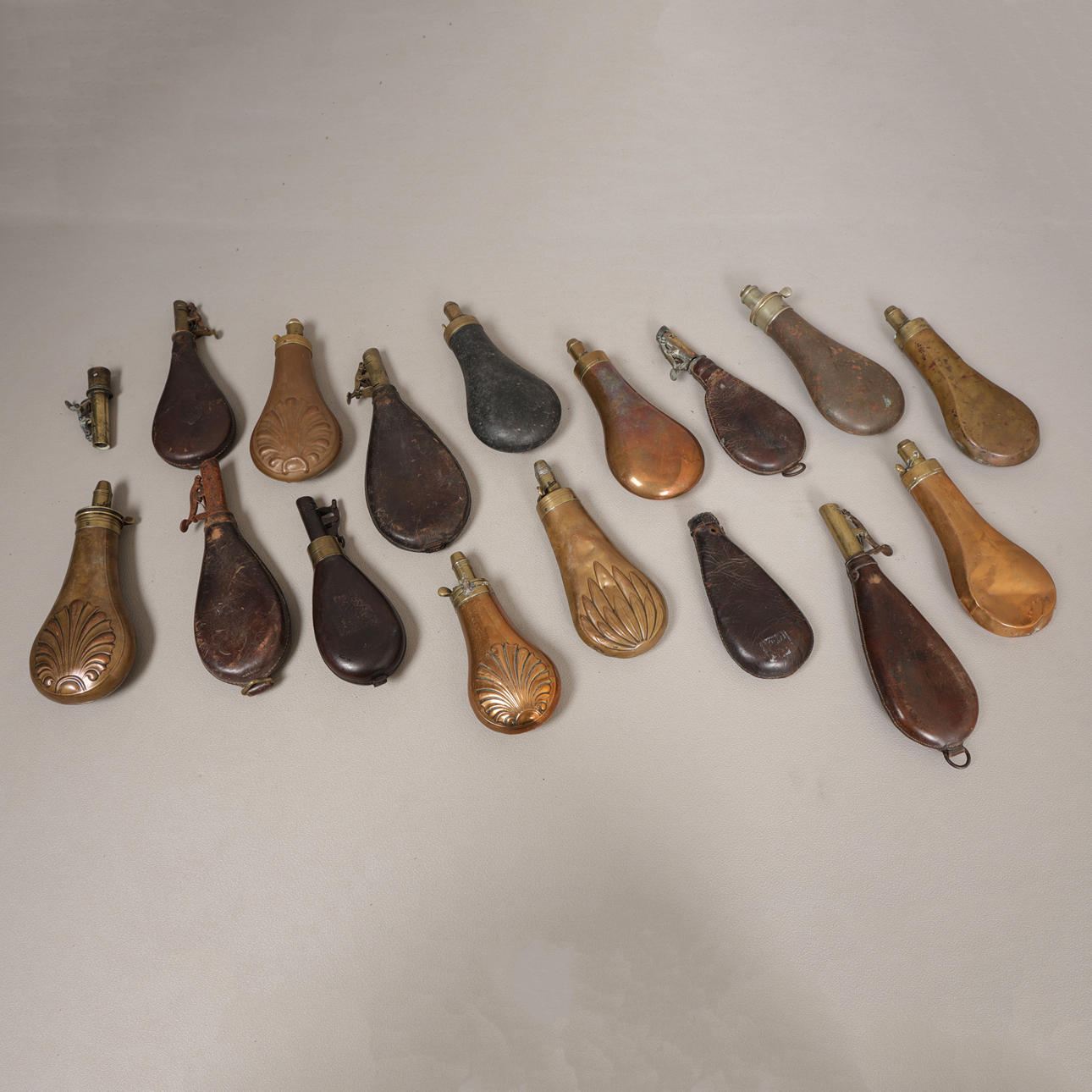 A COLLECTION OF SIXTEEN 19TH CENTURY AND LATER POWDER & SHOT FLASKS (16 ...