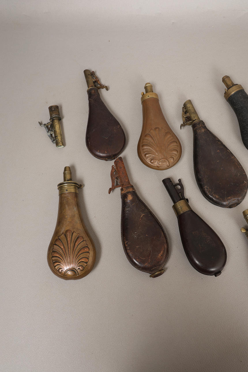 A COLLECTION OF SIXTEEN 19TH CENTURY AND LATER POWDER & SHOT FLASKS (16 ...