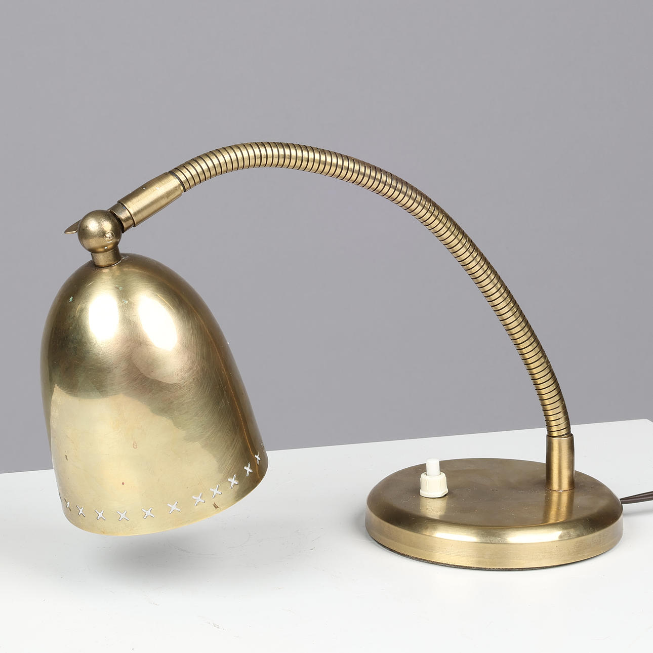 Flexible brass table lamp, adjustable lampshade with cross-shaped perforations, presumably Scandinavian lamp manufacturer, 1940/50s.