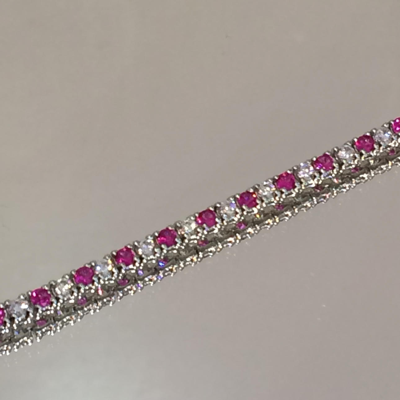 SILVER & RED STONE SET LINE BRACELET.