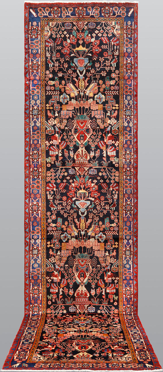 A HAMADAN FIGURAL CARPET. 496 x 120 cm.