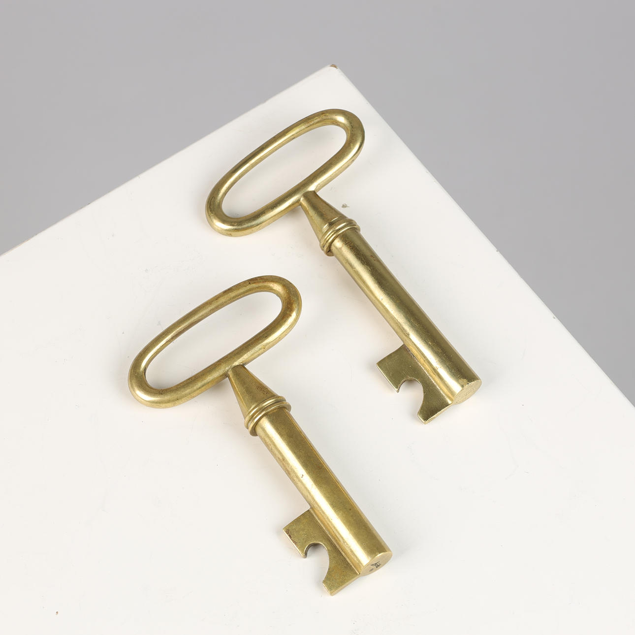 CARL AUBÖCK (1900-1957). Two opening/corkscrews shaped like keys, brass ...