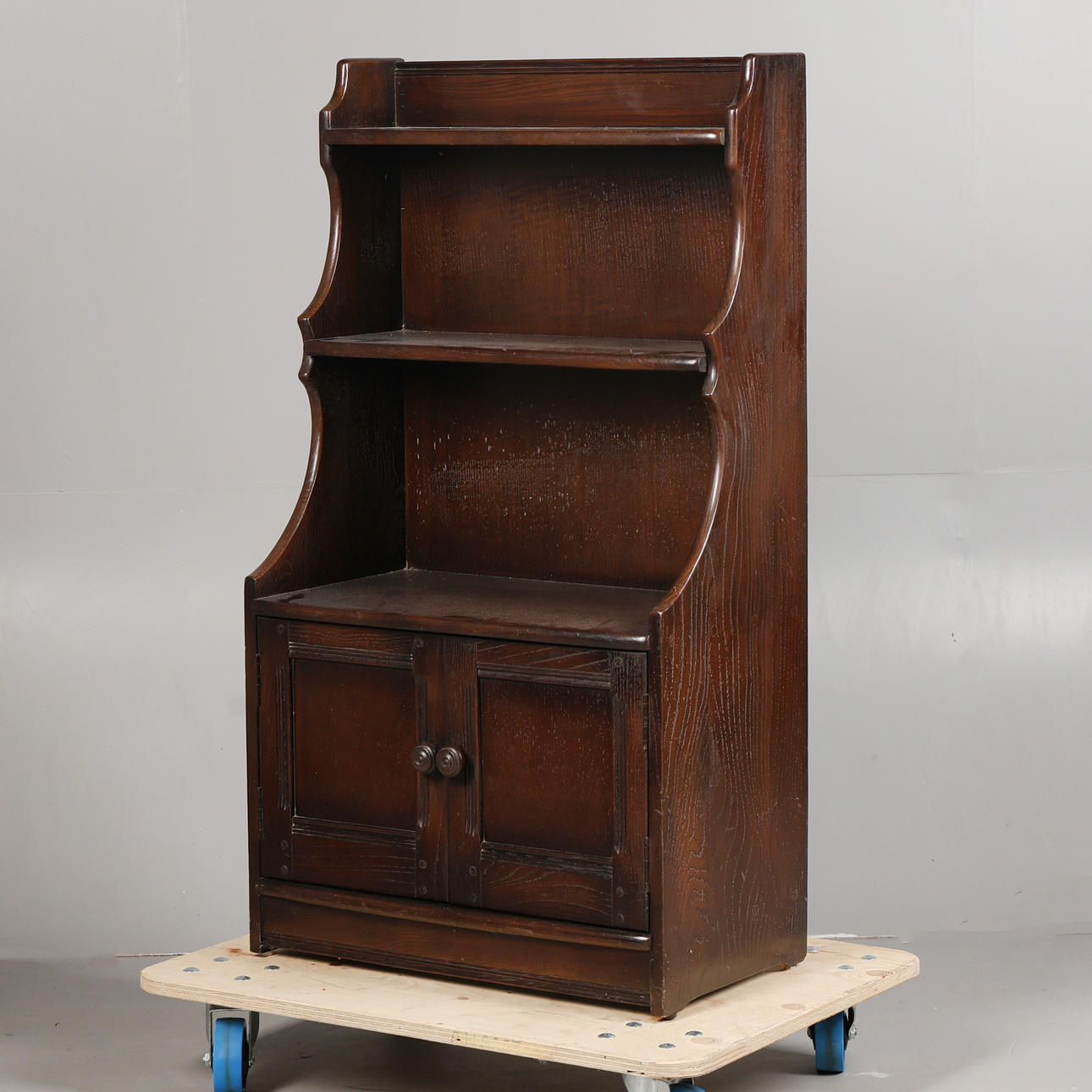 AN ERCOL WATERFALL BOOKCASE.