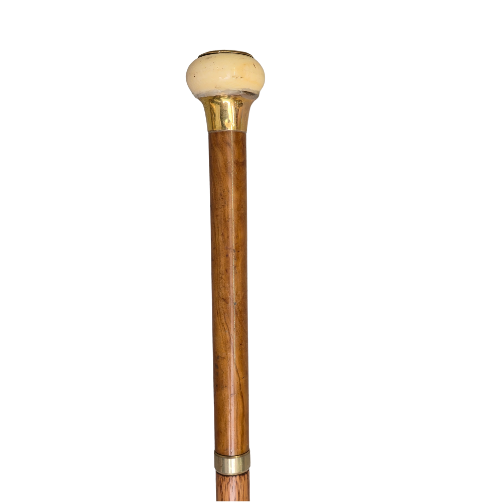 GOLD-PLATED CANE WITH ROUND HANDLE.