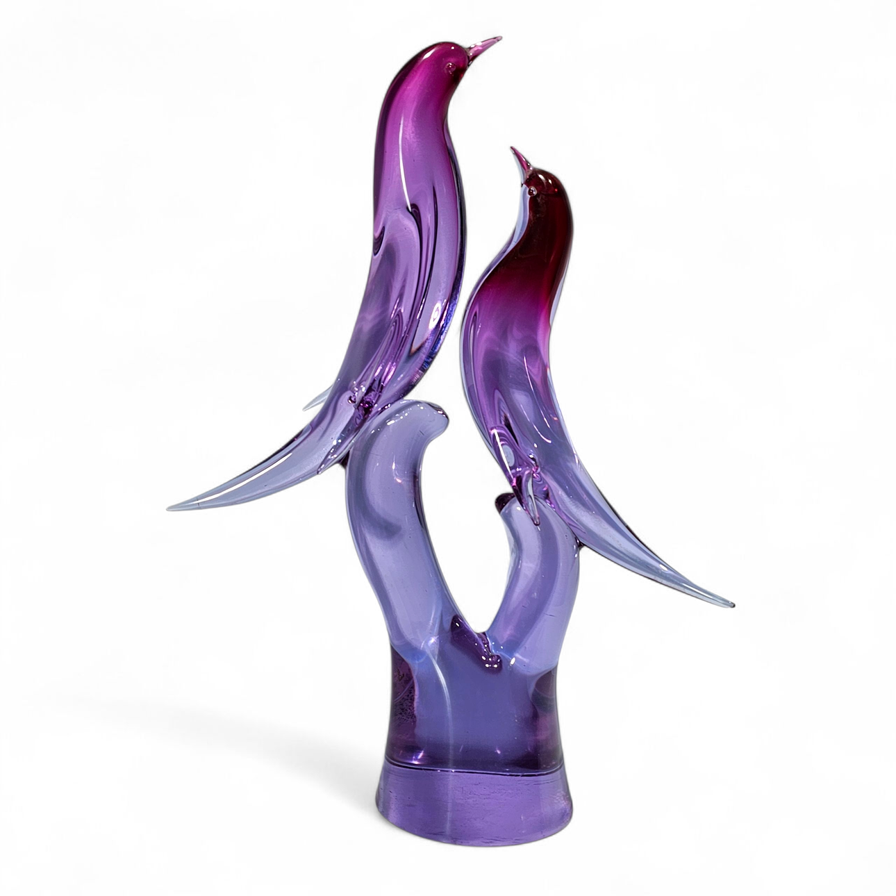Violet-colored blown glass bird figure in gradient.