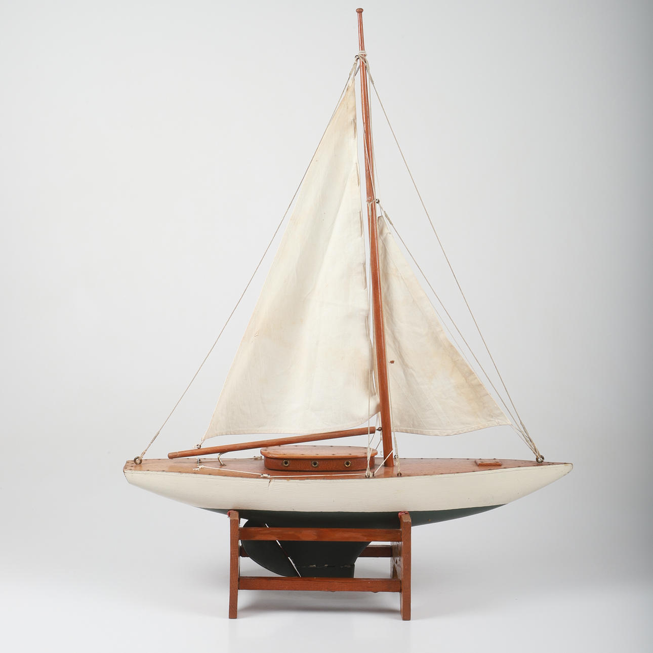 A teak/textile model boat, 20th century.