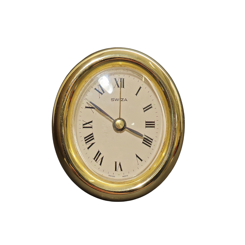 SWIZA. OVAL BRASS TABLE CLOCK.
