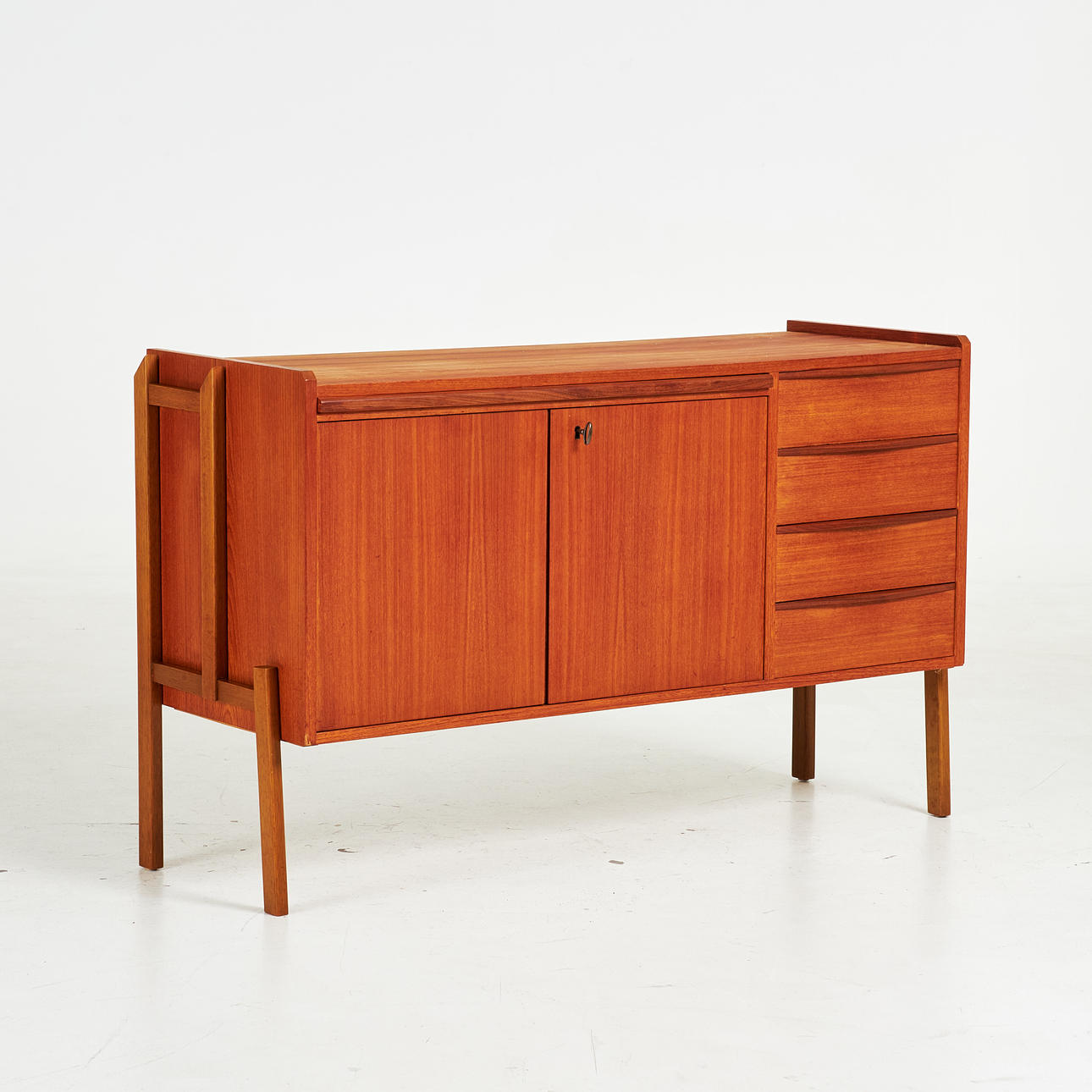 A mid 20th century teak sideboard with lockable cabinet, pull-out desk.