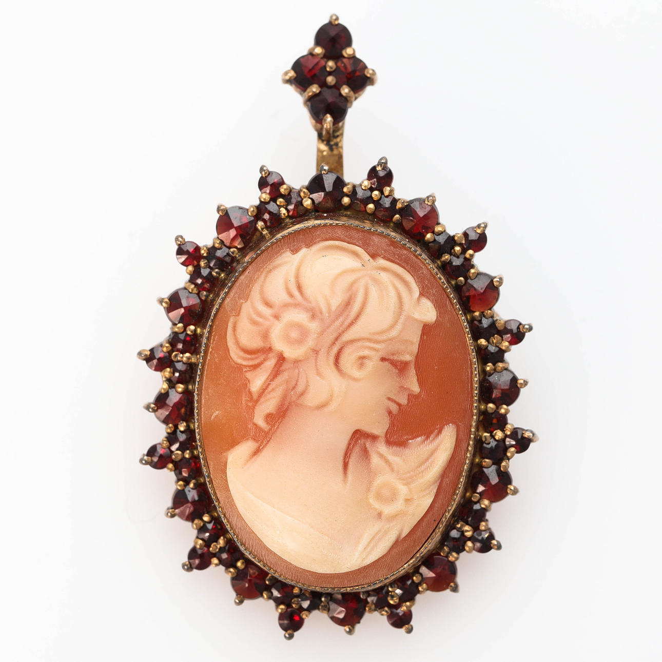 PENDANT/BROOCH, gilt silver, garnets and seashell cameos.