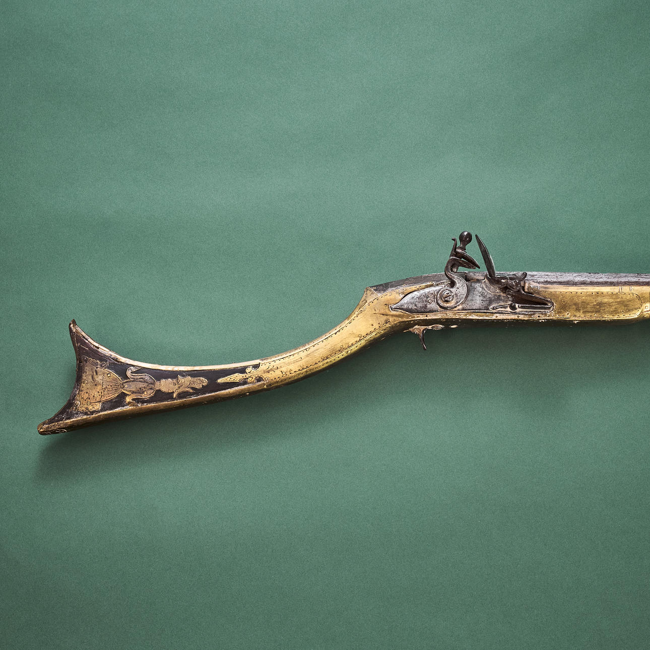 A CARIOPHILI FLINTLOCK RIFLE, Greece, partly clad in brass plate, upper ...