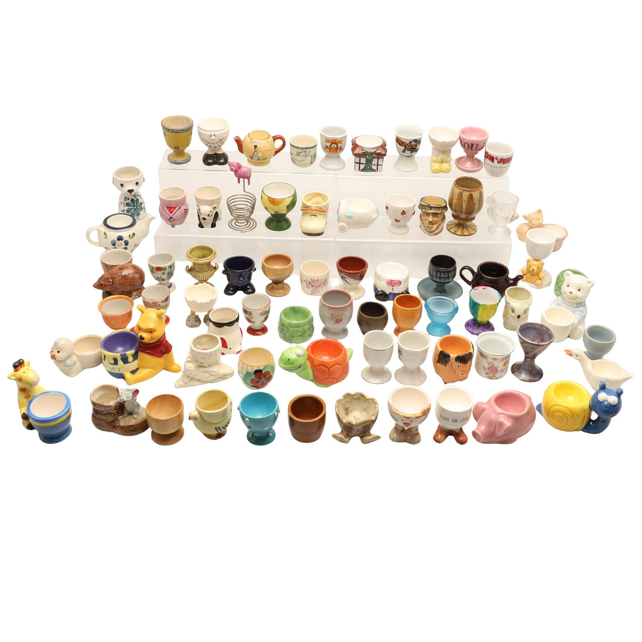 A COLLECTION OF CERAMIC EGGCUPS.