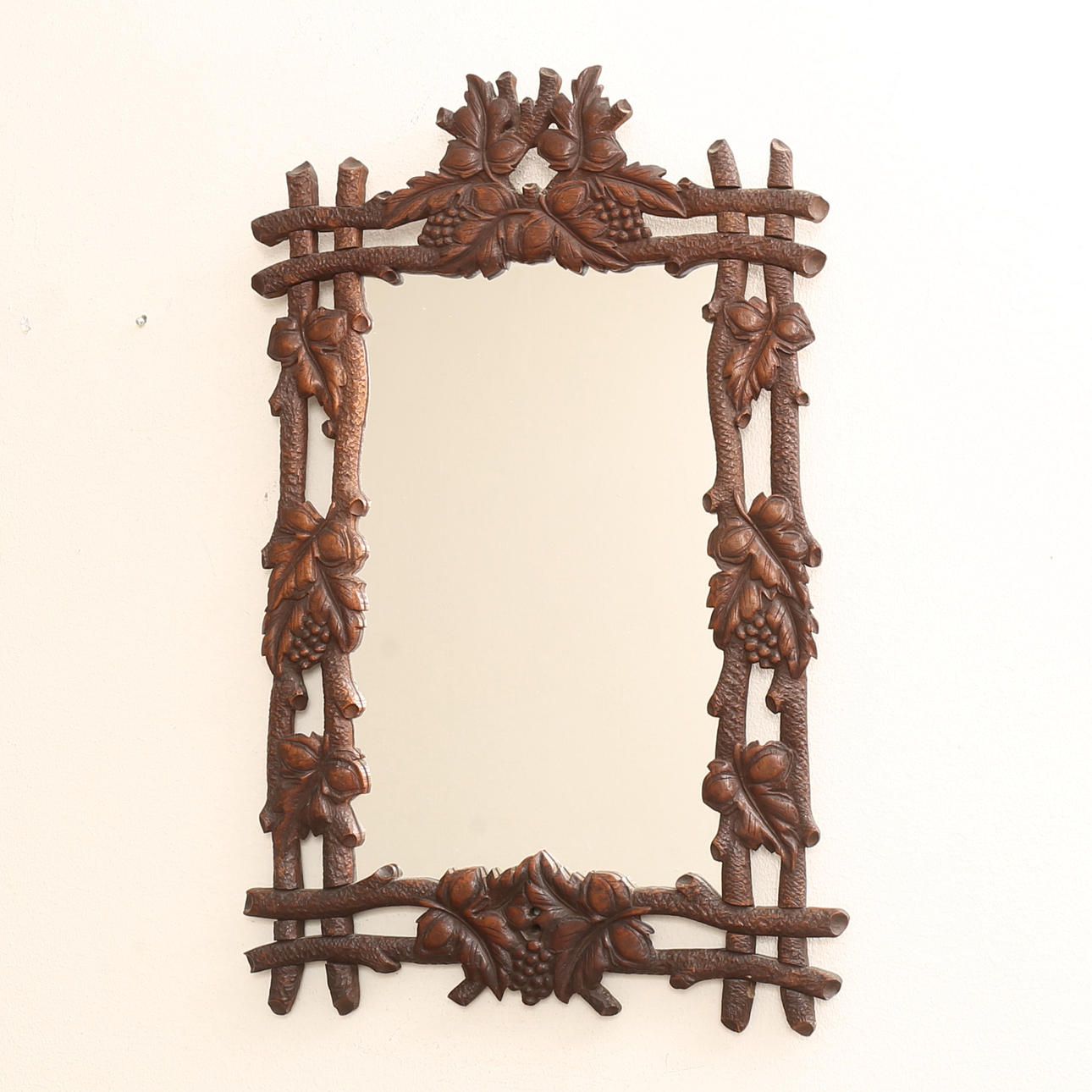 A mirror, cut wood, 20th century.