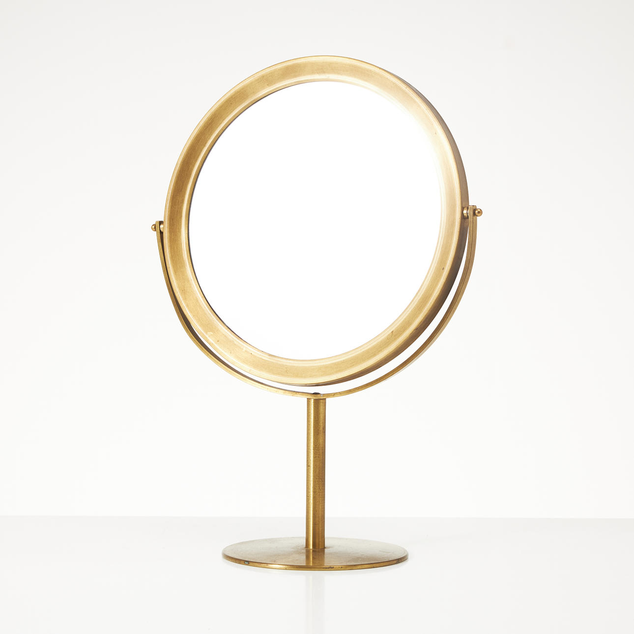 A brass mirror, 1950s/60s.
