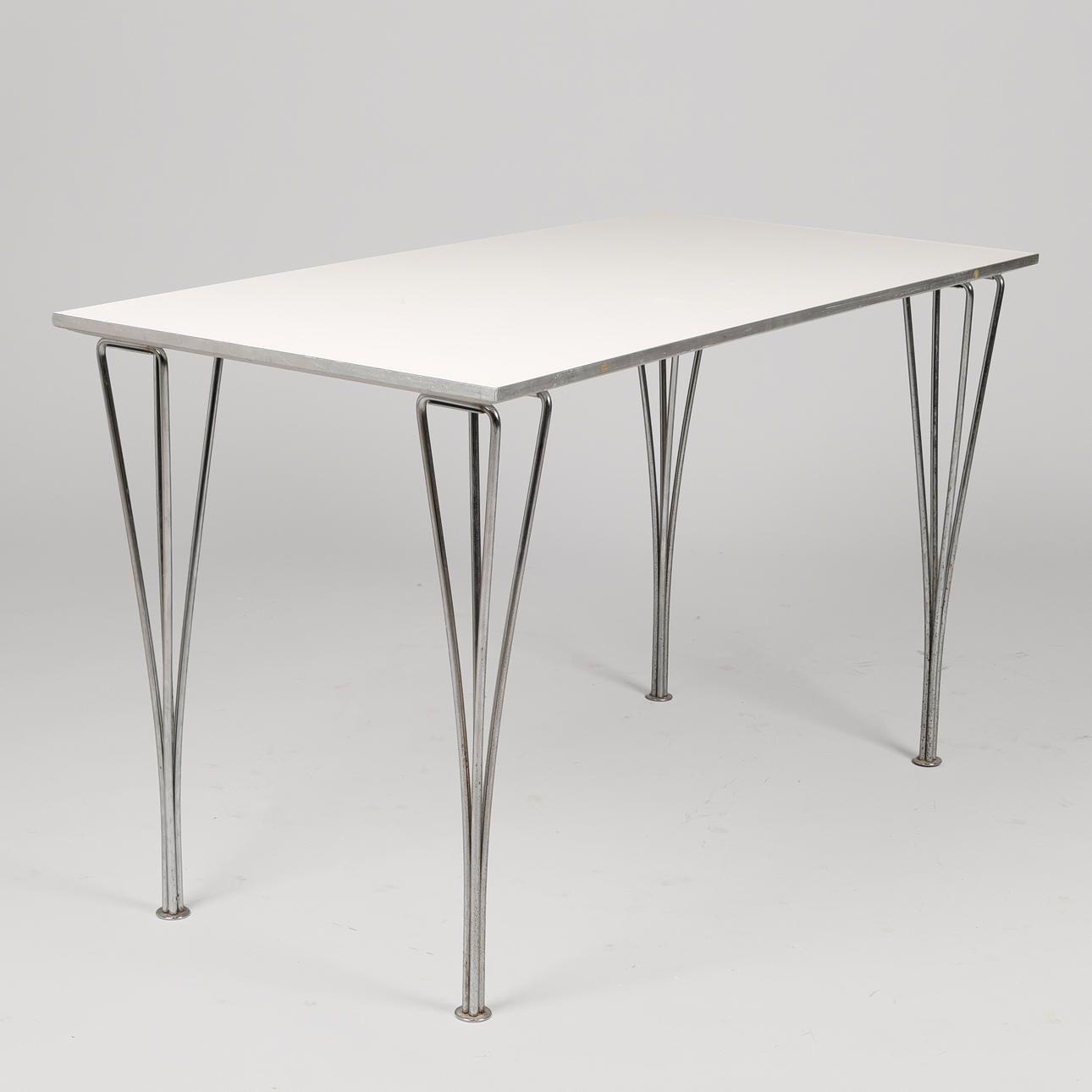 PIET HEIN. Rectangular dining table, white laminate top, chrome-plated metal buckle, Fritz Hansen, Denmark, dated 1986.