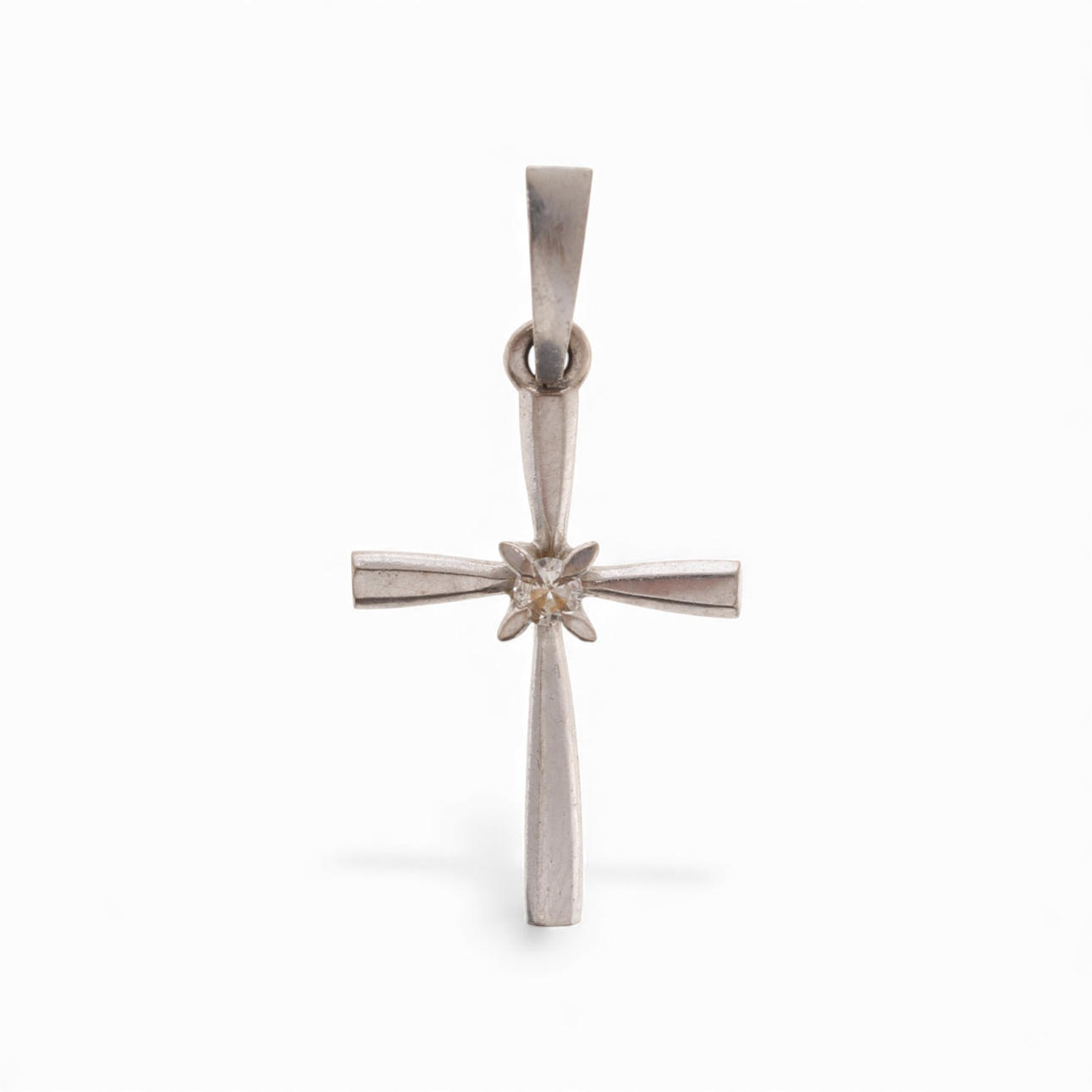 Pendant cross with diamond.