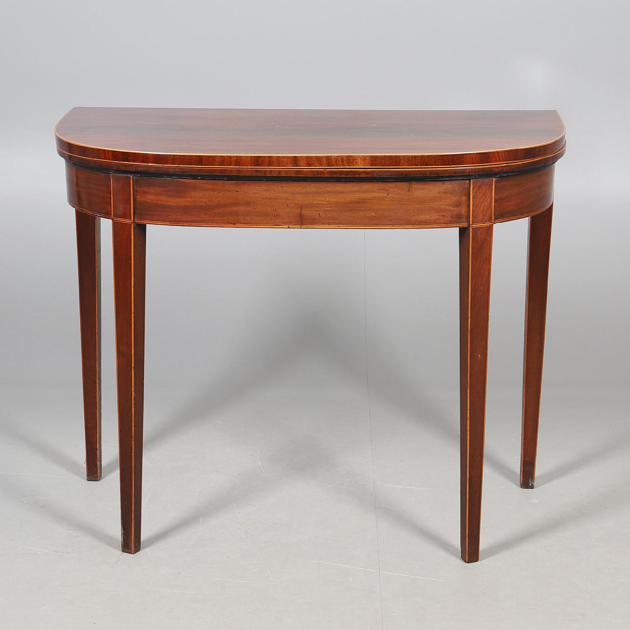A MAHOGANY D SHAPED CARD TABLE.