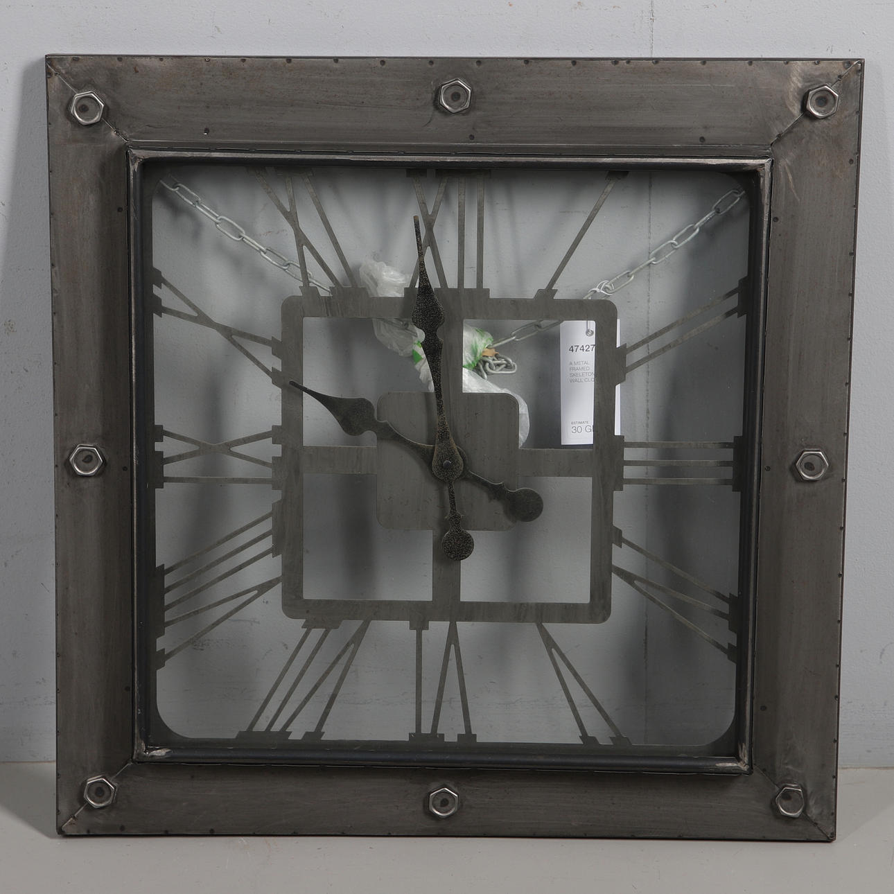 A METAL FRAMED SKELETON WALL CLOCK.