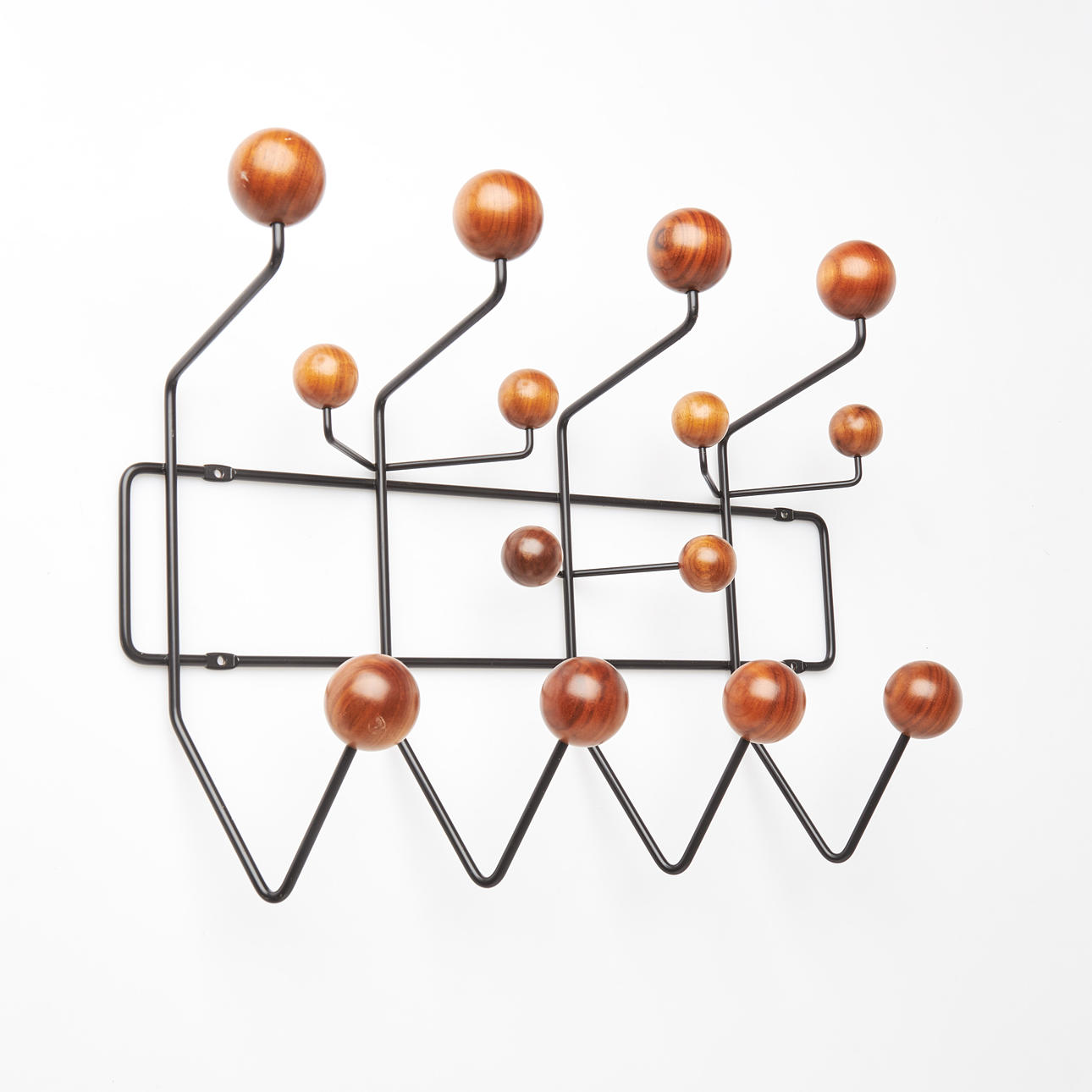 RAY & CHARLES EAMES. COAT HANGER, “Hang it all”, knobs in walnut, black lacquered, Vitra.