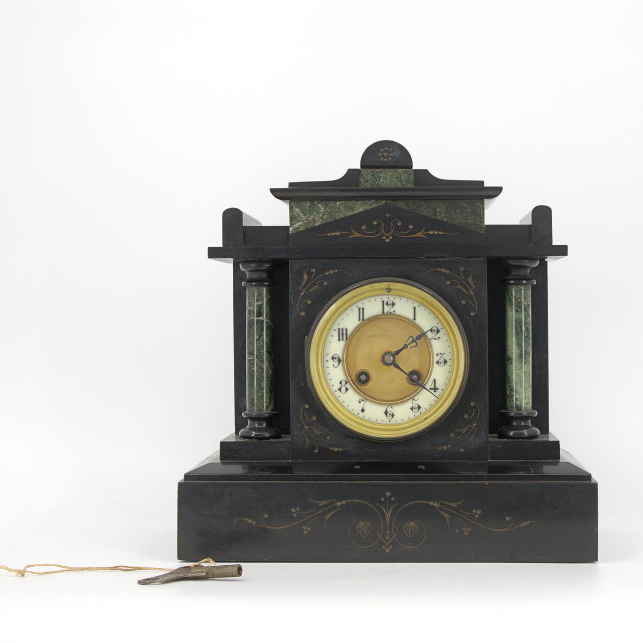A stone table clock, marble columns, 20th century.