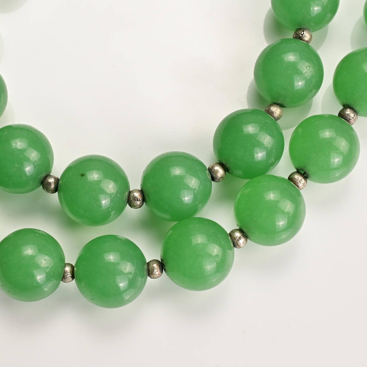 TWO GREEN STONE BEADED NECKLACES TOGETHER WITH ONE OTHER STRING OF ...