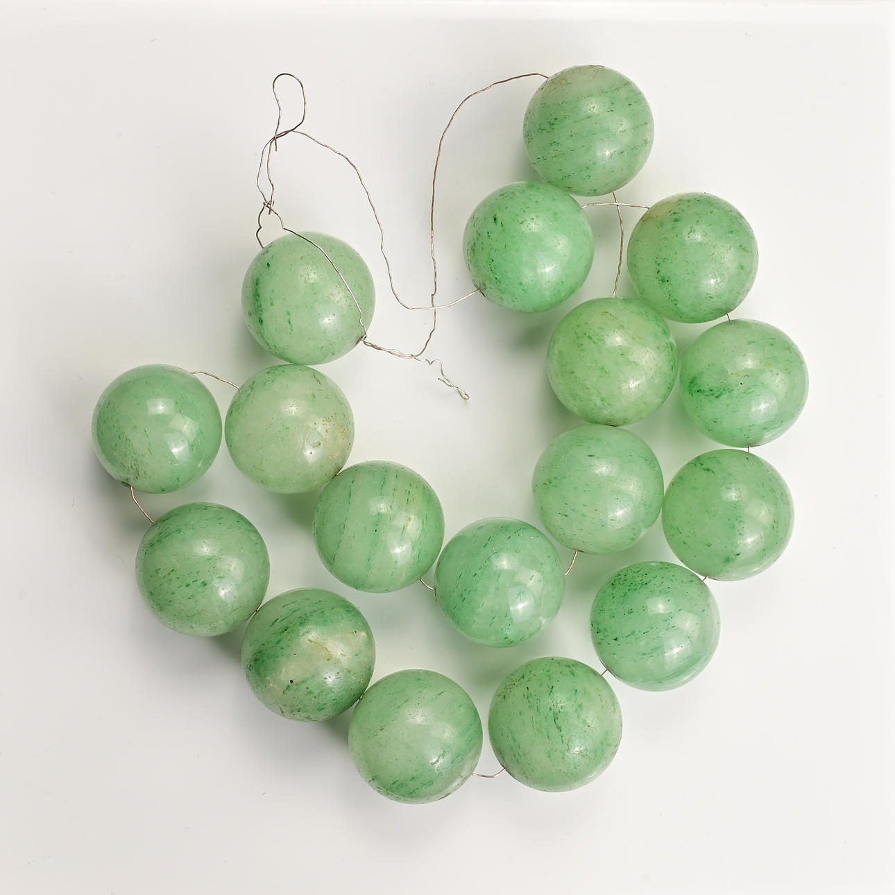 TWO GREEN STONE BEADED NECKLACES TOGETHER WITH ONE OTHER STRING OF ...