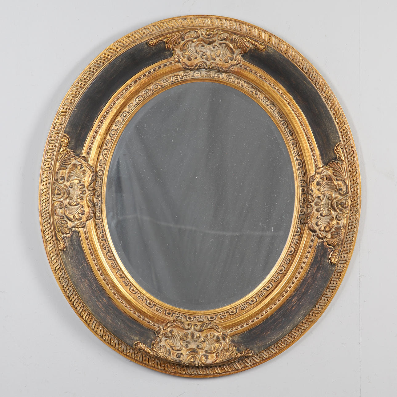 LARGE GILDED OVAL WALL MIRROR.
