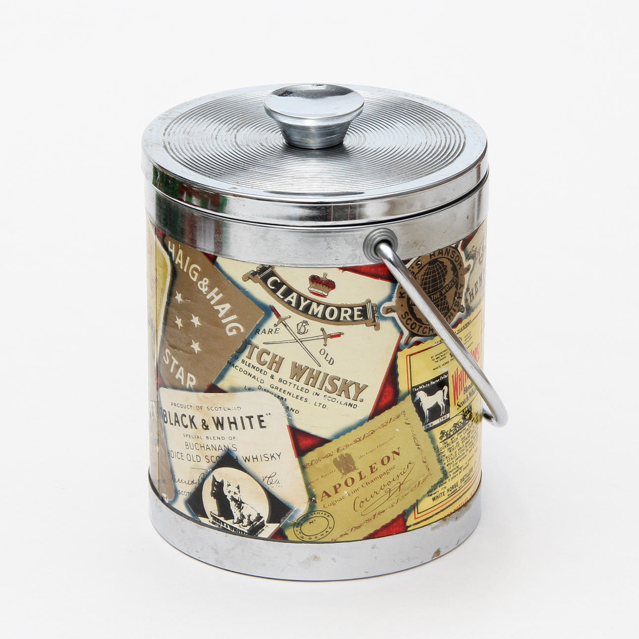 An ice bucket, metal, with a motif of whiskey labels. Silver & Metals ...