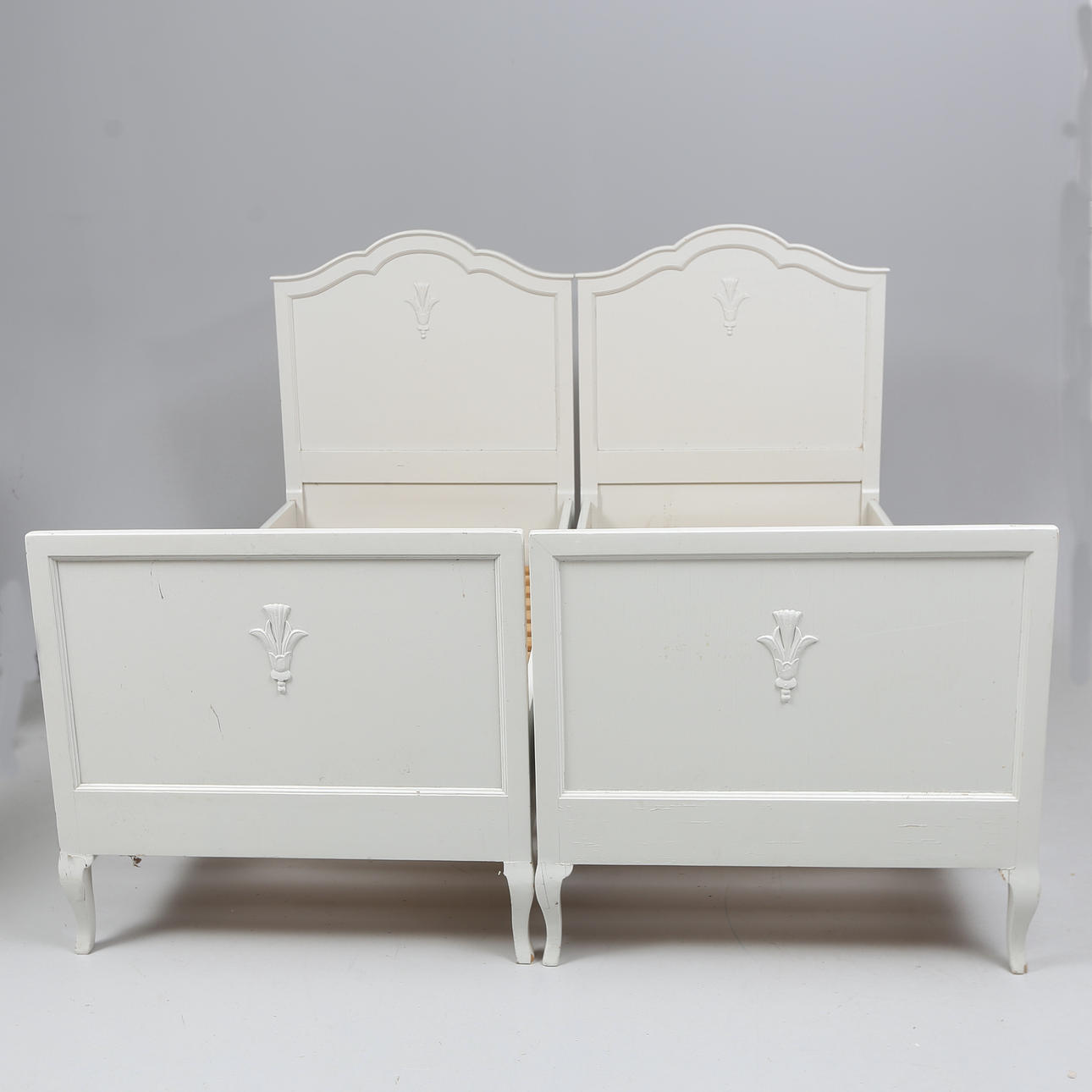 A pair of Swedish Grace painted bed frames, 1920s.