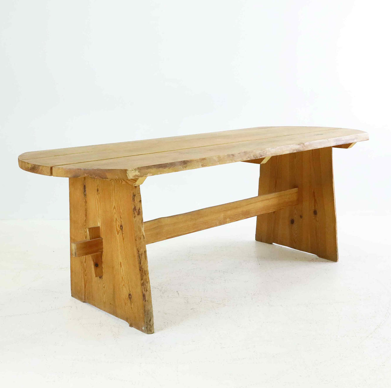 BENT TABLE, rough-hewn pine, 20th century.