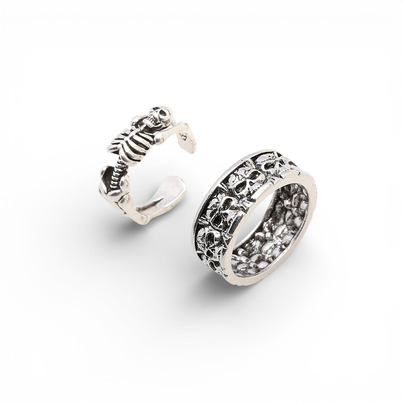 Two skeleton-shaped rings and skulls.
