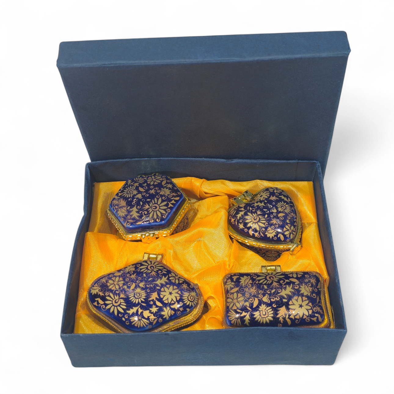 Four porcelain collector's boxes with geometric patterns.