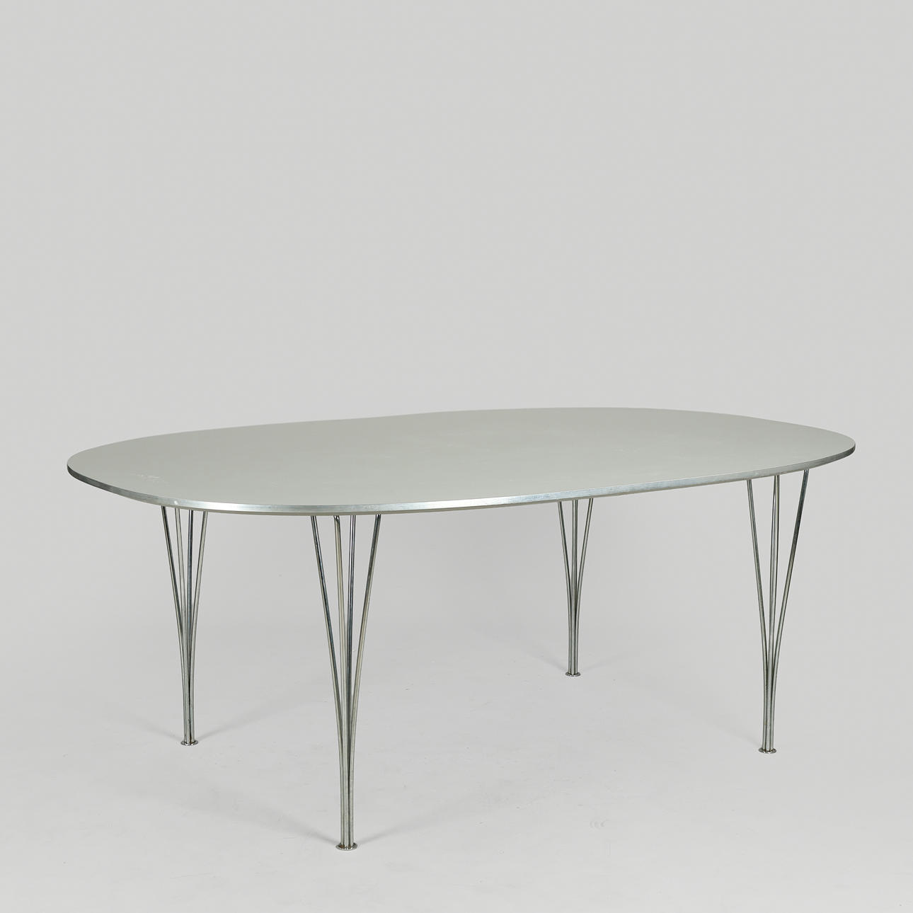 BRUNO MATHSSON & PIET HEIN. "Superellipse" dining table with grey laminate top, span legs of chrome-plated metal, 180 x 120 cm, Fritz Hansen, Denmark, 2000.