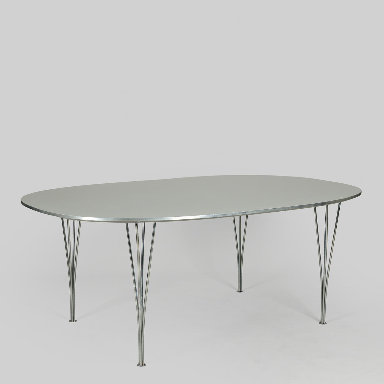BRUNO MATHSSON & PIET HEIN. "Superellipse" dining table with grey laminate top, span legs of chrome-plated metal, 180 x 120 cm, Fritz Hansen, Denmark, 2000.