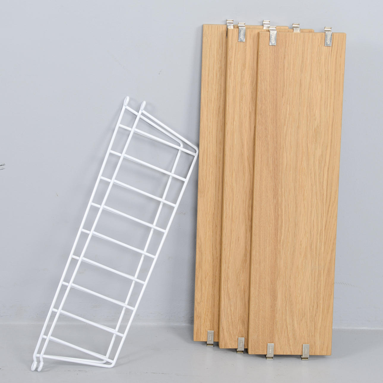 NILS & KAJSA STRINNING. A wall shelf, “String”, 2000s.