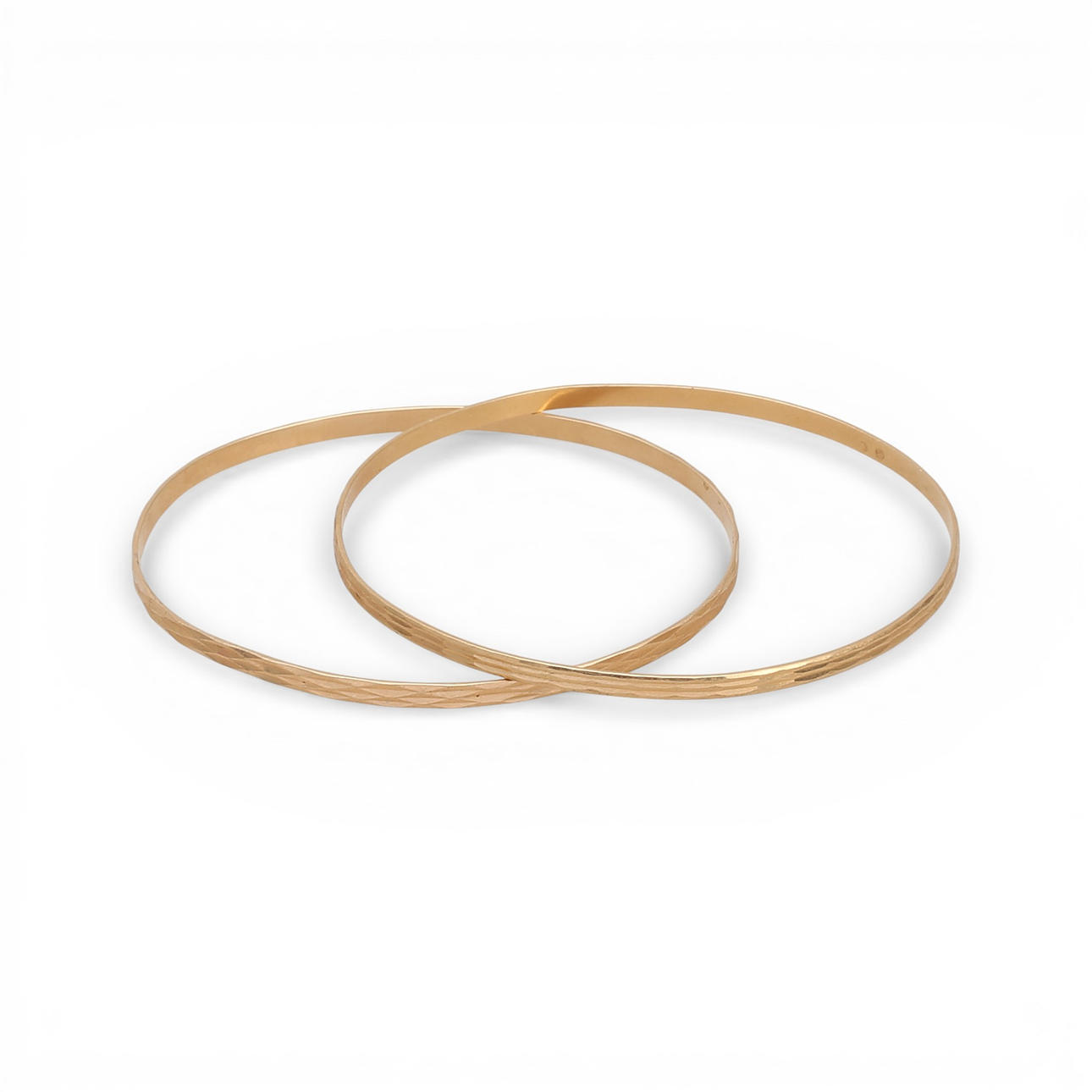 Two gold bangle bracelets.