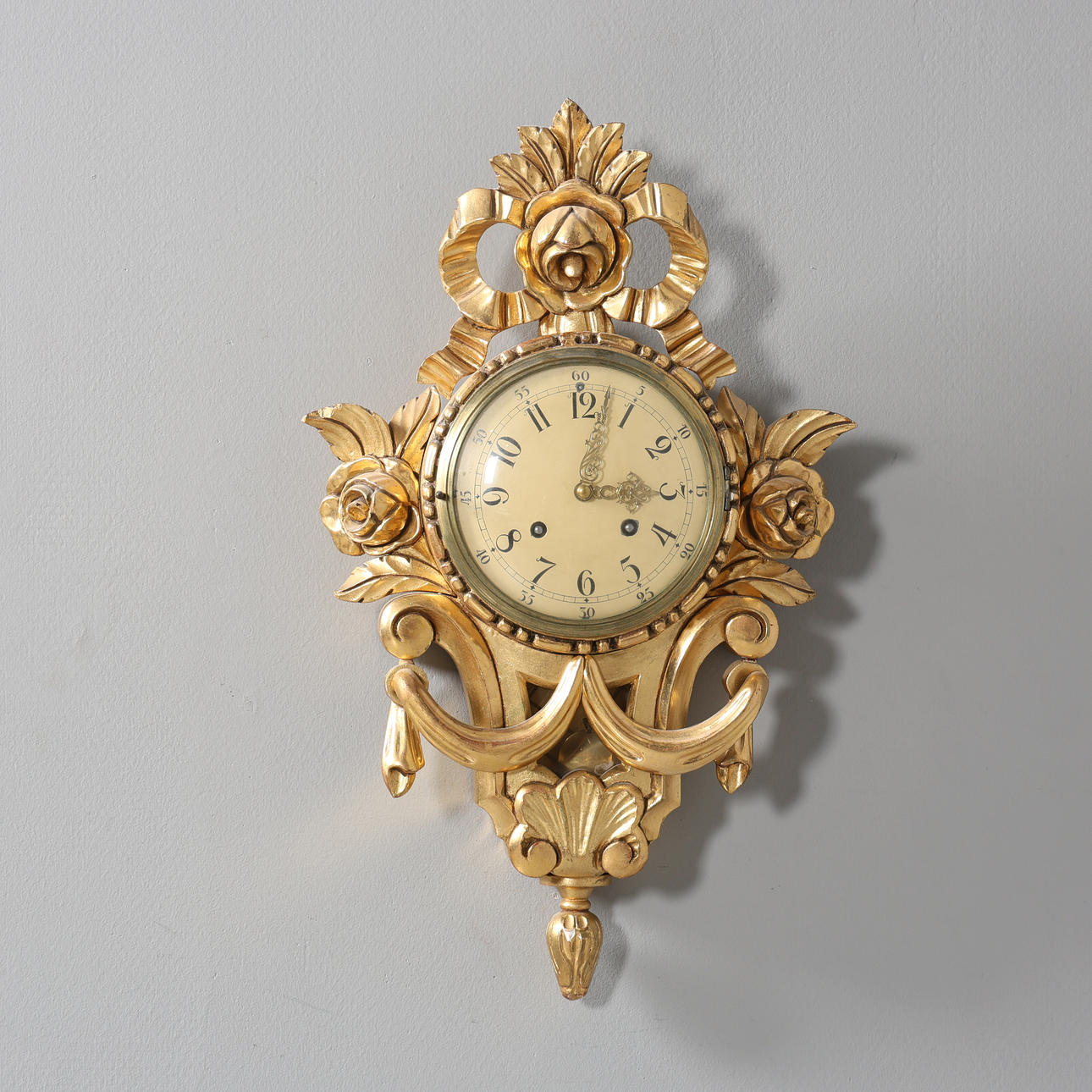 A wall clock, gilded wood, Rococo style, Exacta.