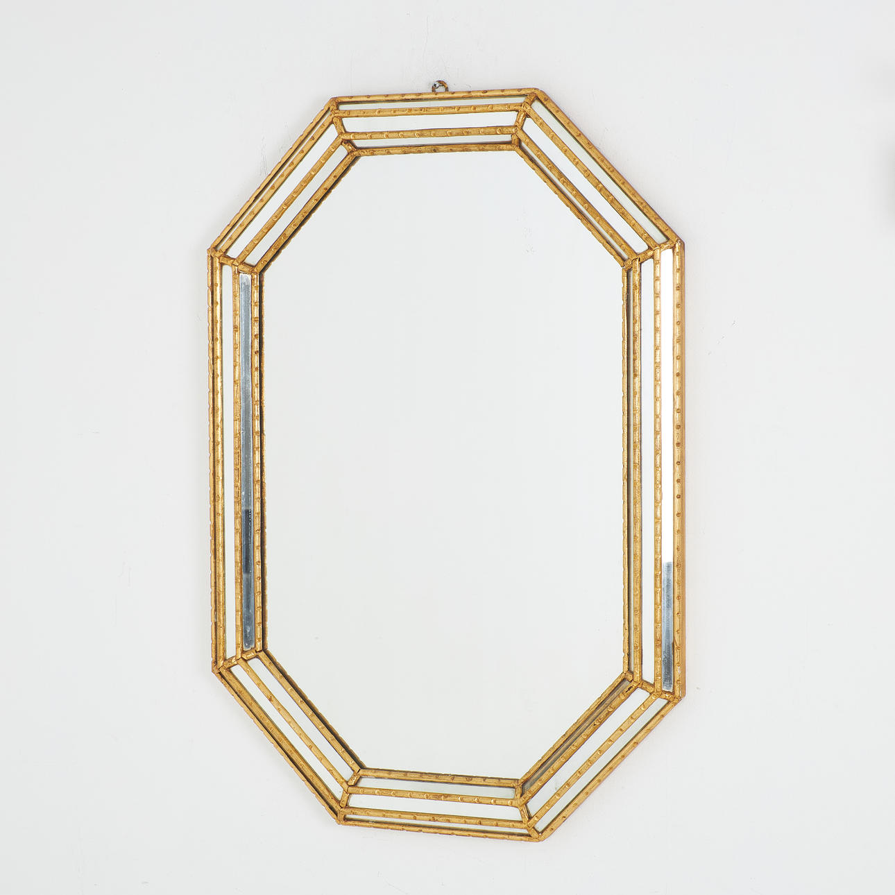 A 20th century mirror, octagonal bronzed frame with mirror glass.